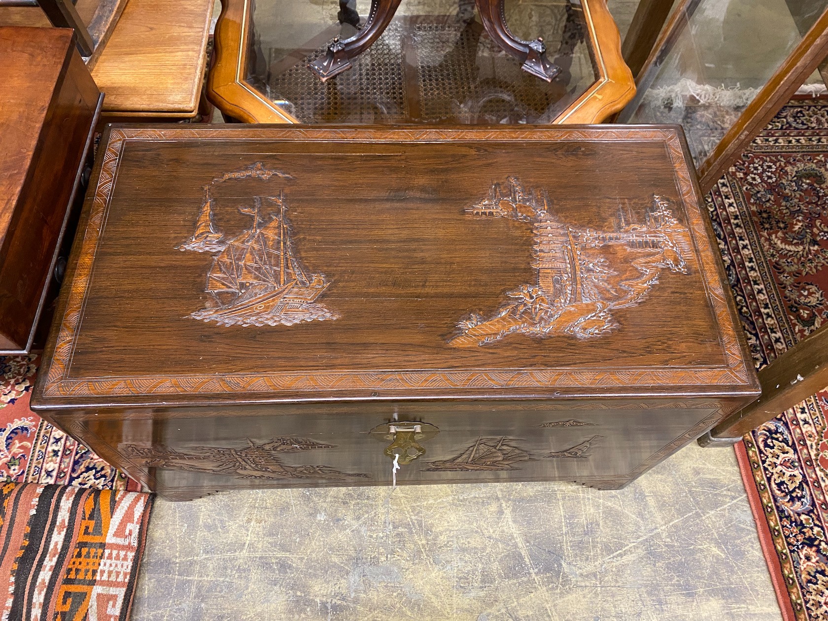 A 20th century Chinese carved camphorwood trunk, length 104cm, depth 52cm, height 62cm